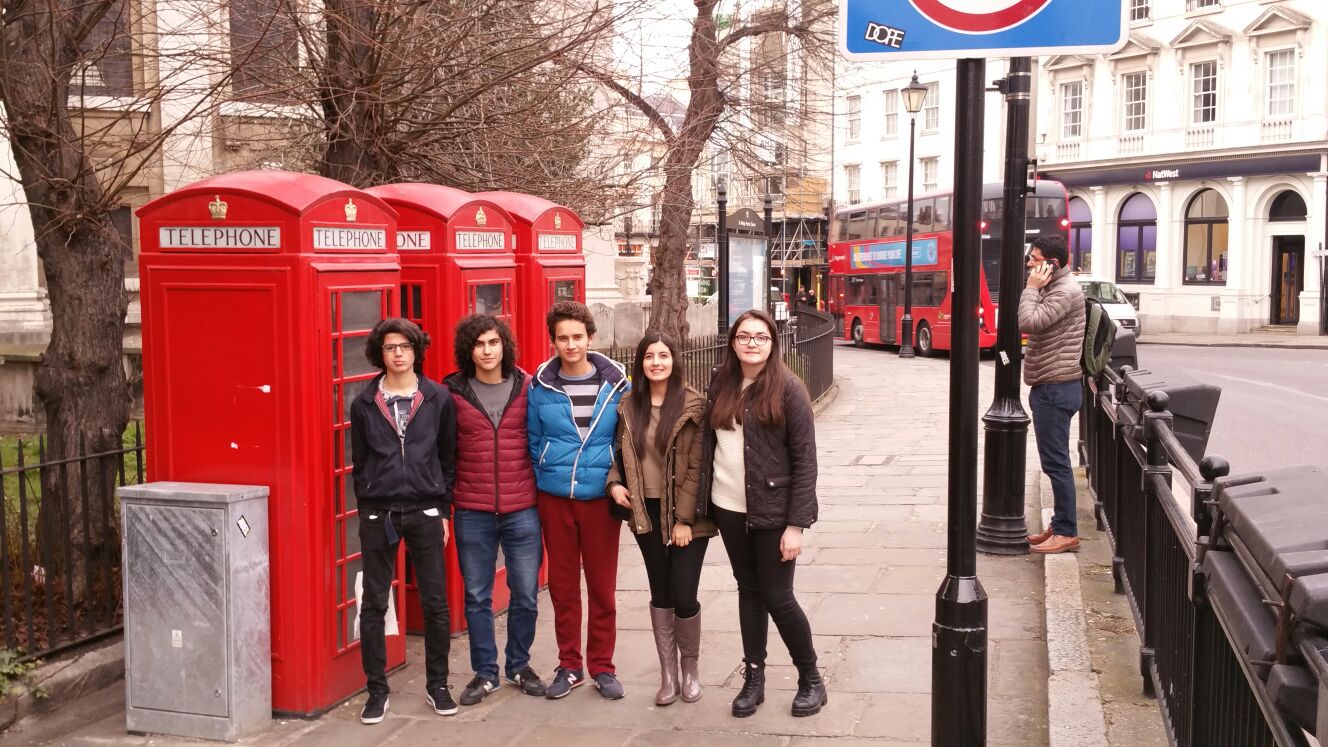 Students by the iconic red telephone boxes in London